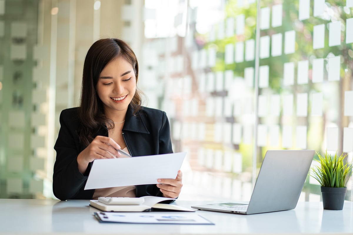 Consultant reviewing financial graphs and real estate investment data on a laptop